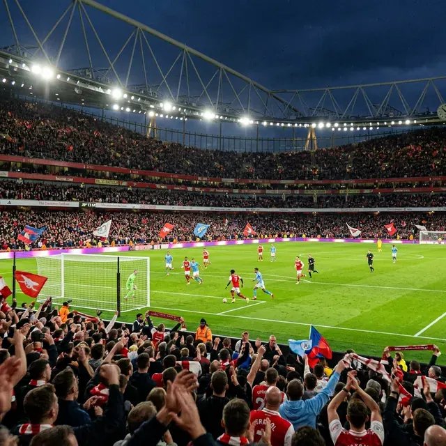 Packed stadium under the lights during a live game